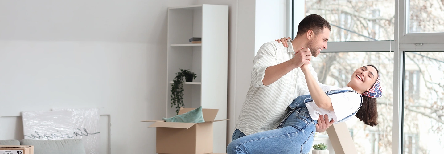 A man and a woman dancing in their home