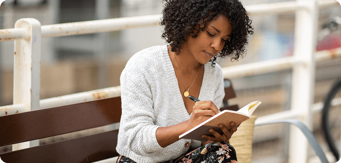 A woman thinking and writing