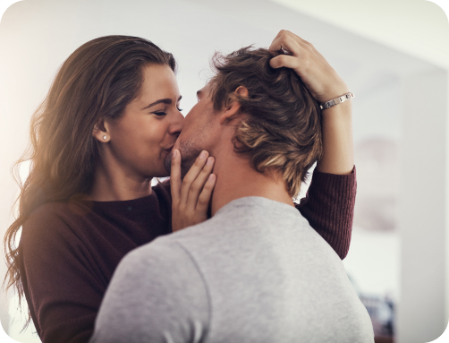 A man and a woman kissing.